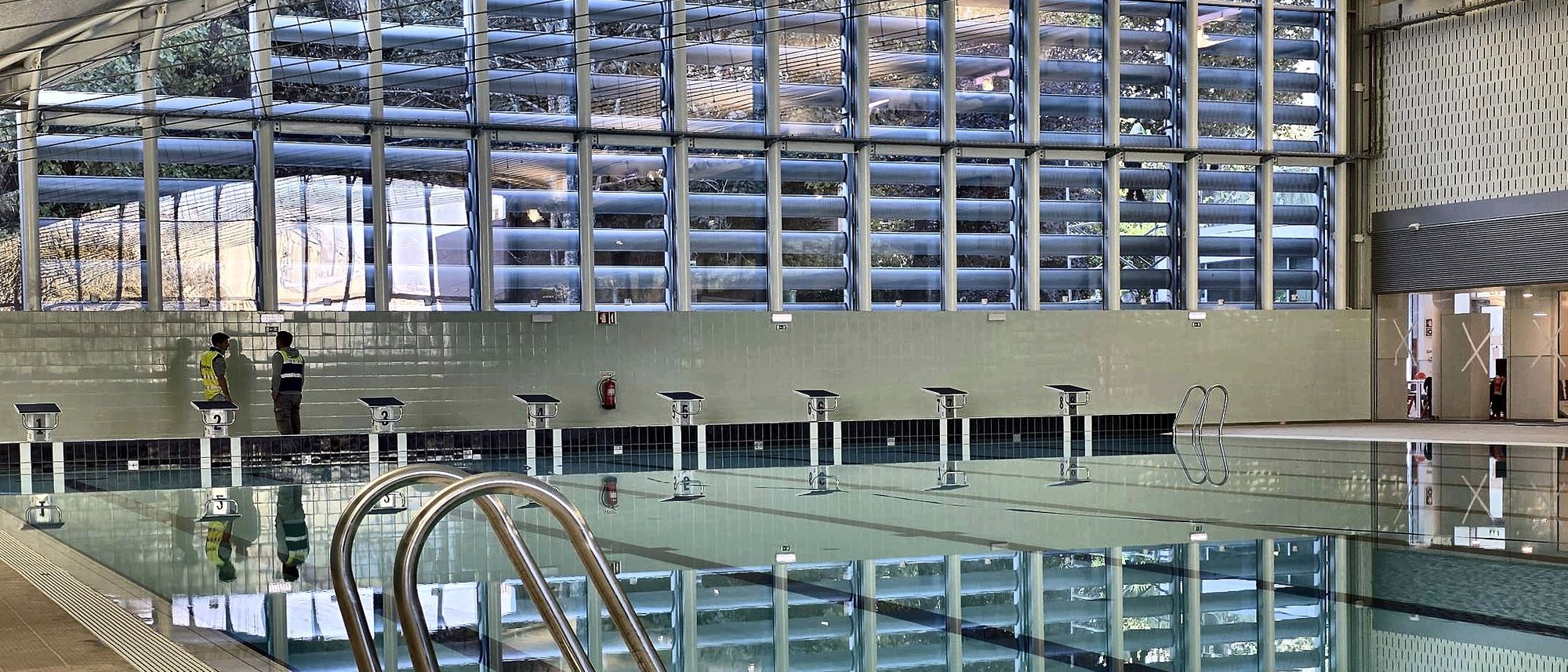 Interior da Piscina Municipal de Maravedi com a fachada solar de recetores RTS PLUS vista através do vidro